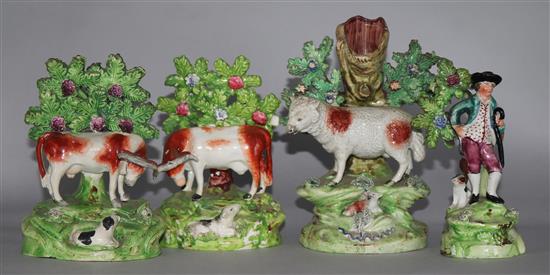 A Walton pottery sheep and lamb spill vase, two Staffordshire pottery cow and calf groups & a Staffordshire of a youth and his dog (4)